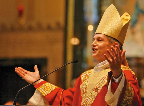 NEW BISHOP FOR DIOCESE — Bishop Thomas John Paprocki sings Jesus Loves You by Brian Littrell, former lead singer for the Back Street Boys, during his Mass of Reception and Installation as the ninth bishop of the Catholic Diocese of Springfield in Illinois at the Cathedral of the Immaculate Conception in Springfield on June 22. Photo by Justin L. Fowler/The State Journal-Register