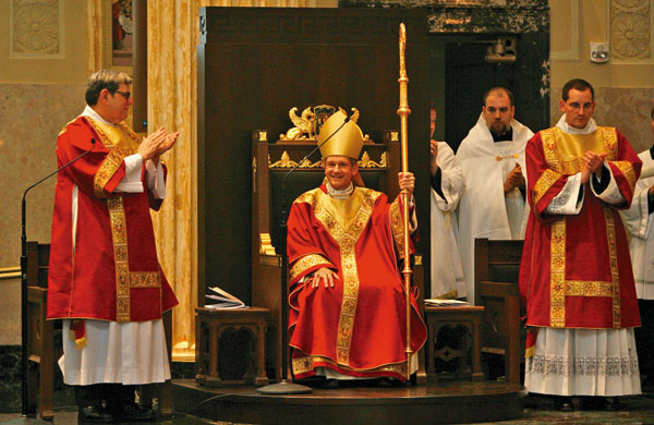 Bishop Paprocki accepts the applause of those attending after being seated by the metropolitan bishop; Cardinal Francis George. Photo by Justin L. Fowler/The State Journal-Register