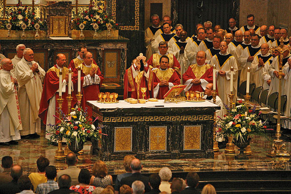 Bishop Paprocki raises the consecrated host during the Eucharistic prayer.  Photo by Justin L. Fowler/The State Journal-Register