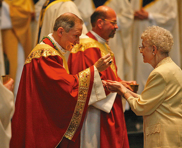 Bishop Paprocki distributes Communion to his mother, Veronica Paprocki. Msgr. Carl A. Kemme is in the background.  Photo by Justin L. Fowler/The State Journal-Register