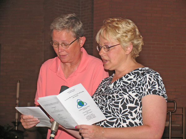 Kathy Rogers, left, of St. Ambrose Parish in Godfrey, and Anne Bone, of St. Elizabeth Parish in Granite City became associates of the Sisters of Divine Providence at a reception and renewal liturgy at Holy Family Church in Granite City. They each made a one-year commitment to share in the spiritual, communal and ministerial life of the sisters.