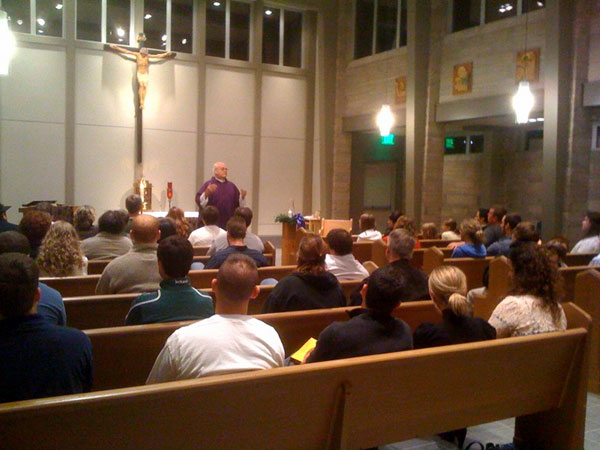 Msgr.  John Ossola gives a homily at a Sunday evening Young Adult Mass in the  chapel at the Catholic Pastoral Center in Springfield. 
