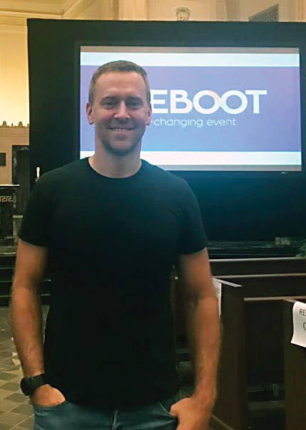 09 29 2019 700 REBOOT Stefanick stands before his presentation screen